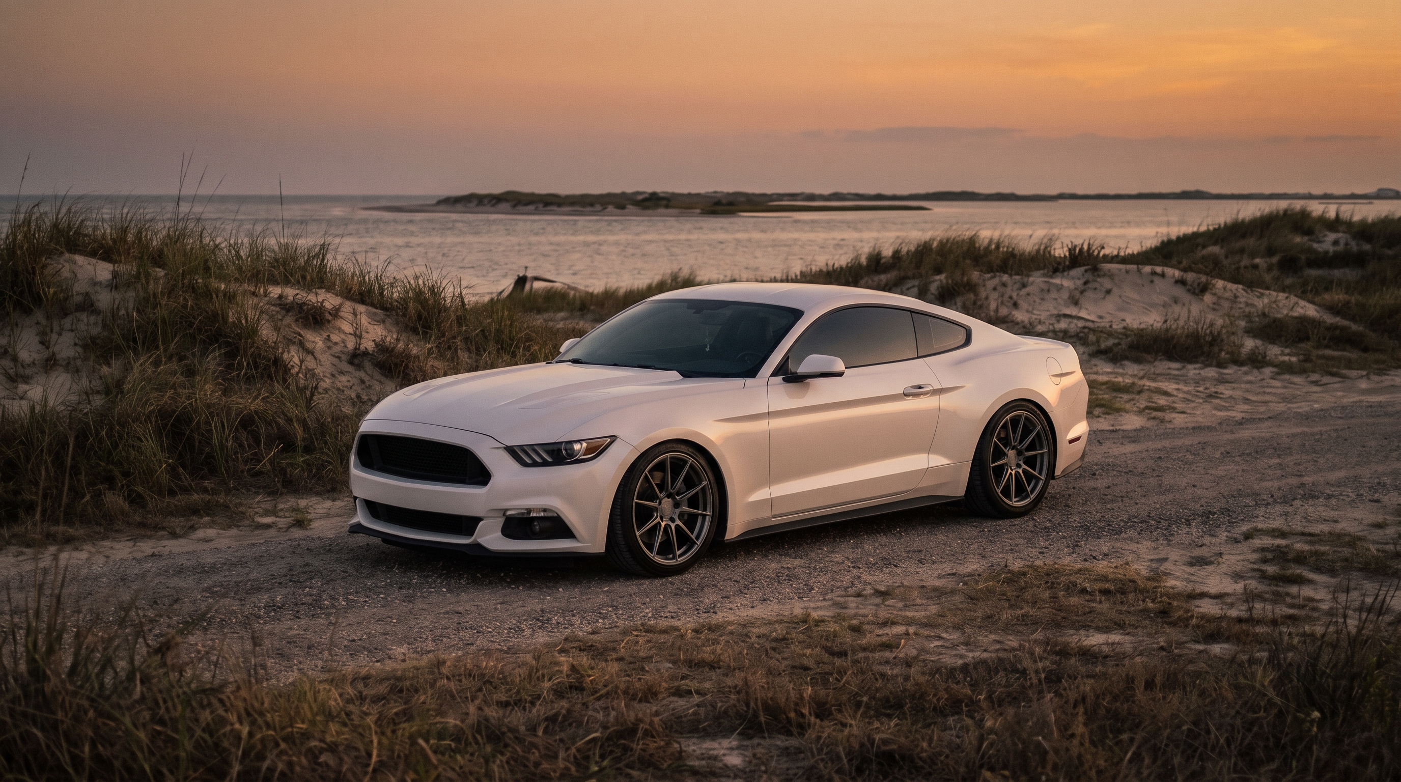 Pearl white S550 Ford Mustang GT on a Texas Gulf coast highway at golden hour