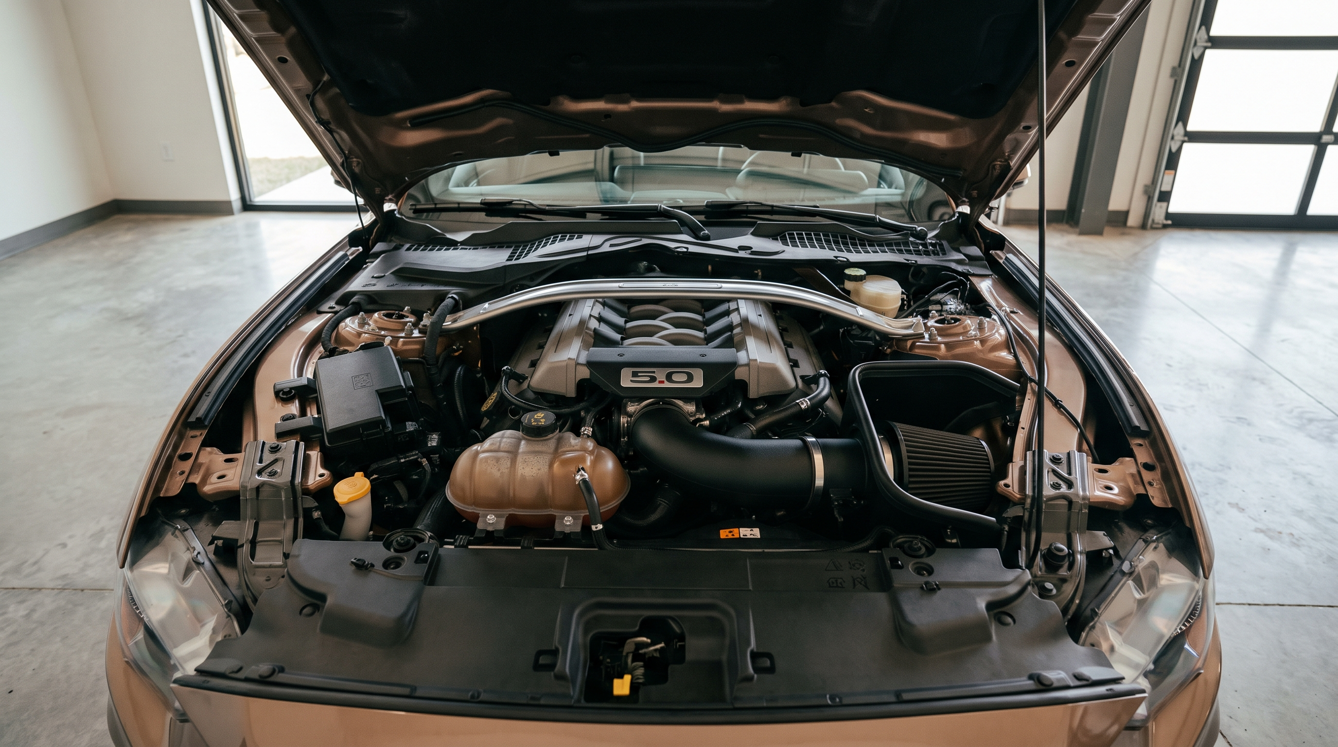 Open engine bay of a 2024+ S650 Ford Mustang GT with a cold air intake on the Coyote V8