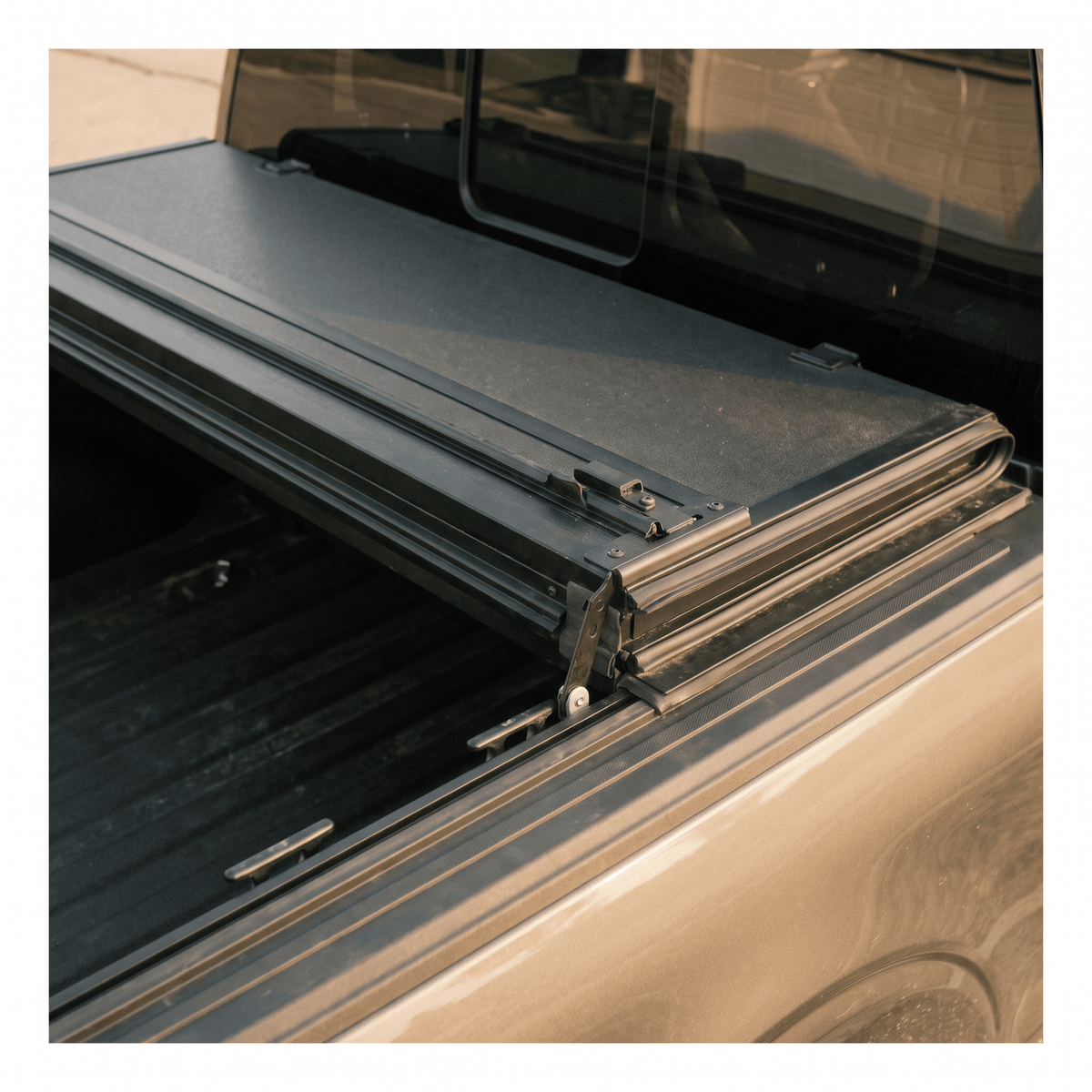 black folding hard tonneau cover on pickup truck bed