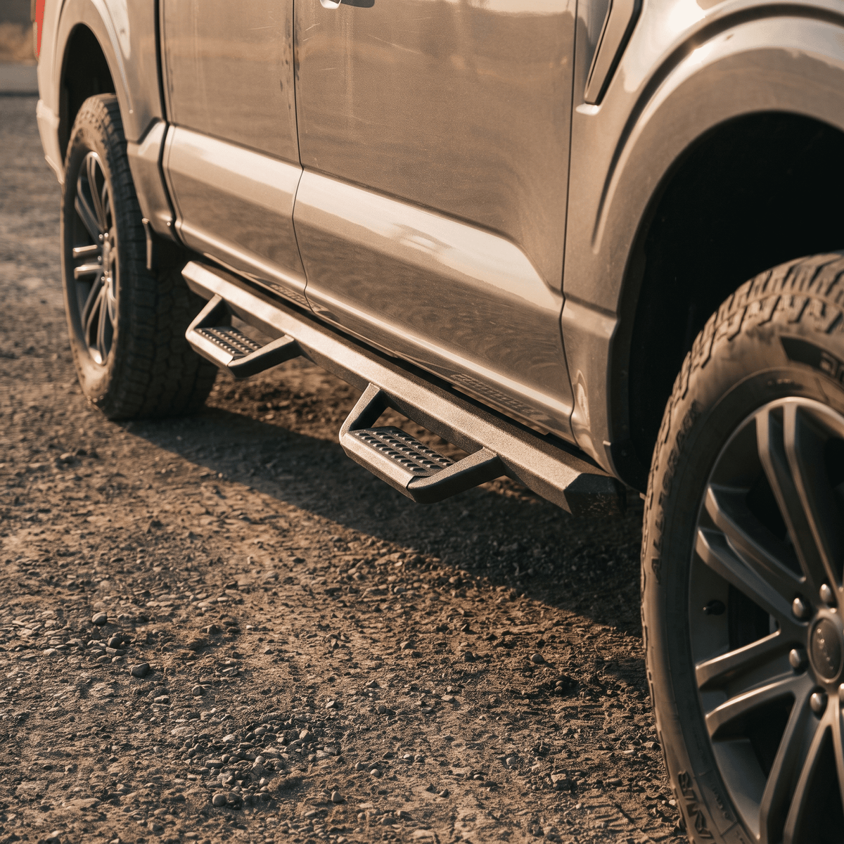 Silver pickup truck with black textured running boards and steps