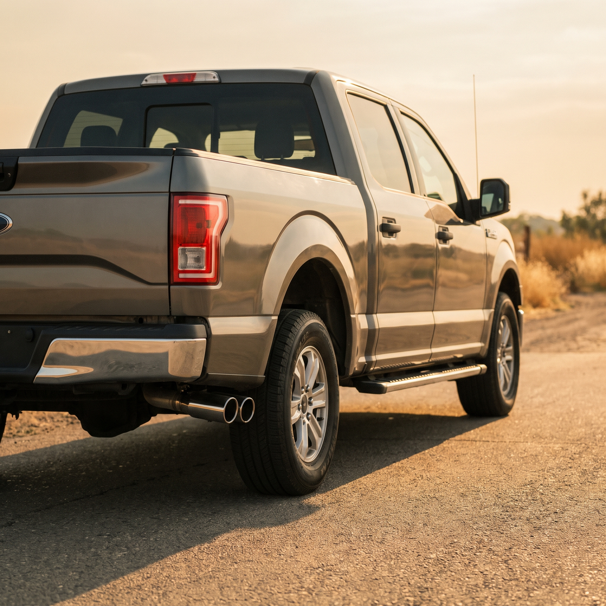 Grey 2015-2020 Ford F-150 with a cat-back exhaust at golden hour