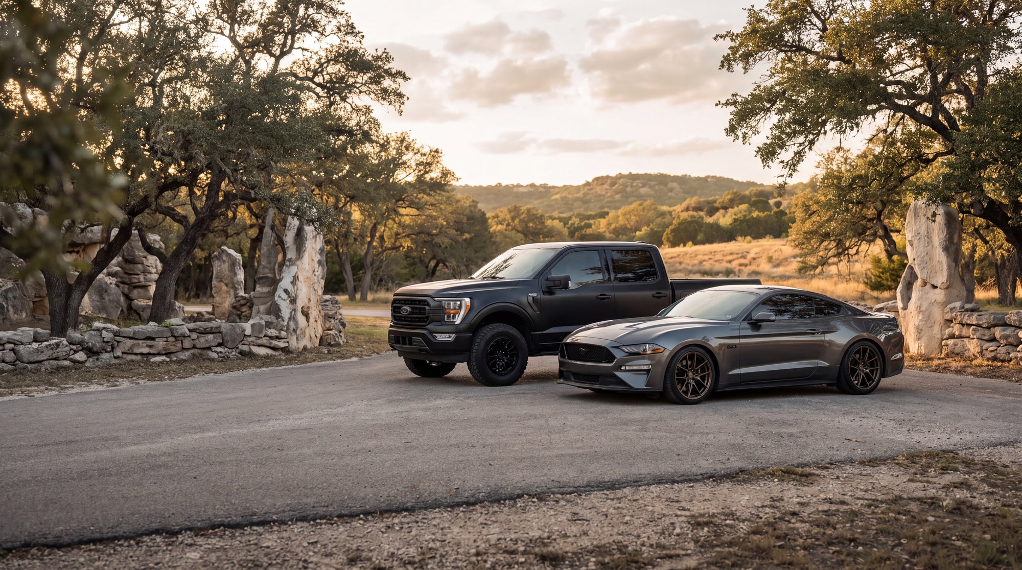 Ford Mustang GT and F-150 parked together on a Texas Hill Country road
